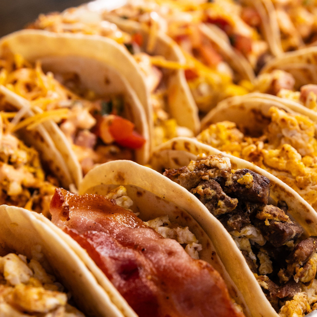Tray of Jurassic Tacos breakfast tacos with scrambled eggs, bacon, steak, and cheese